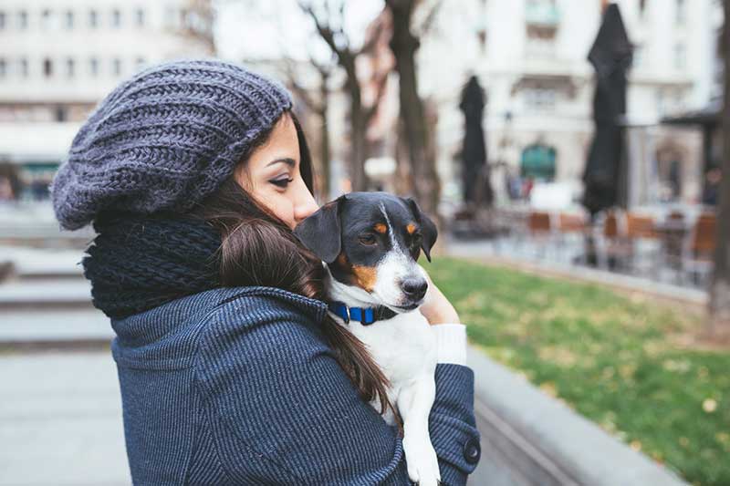 woman holding her dog